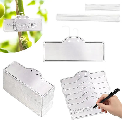 Clear labels with waterproof text, packaging, and a hand writing on one of them.