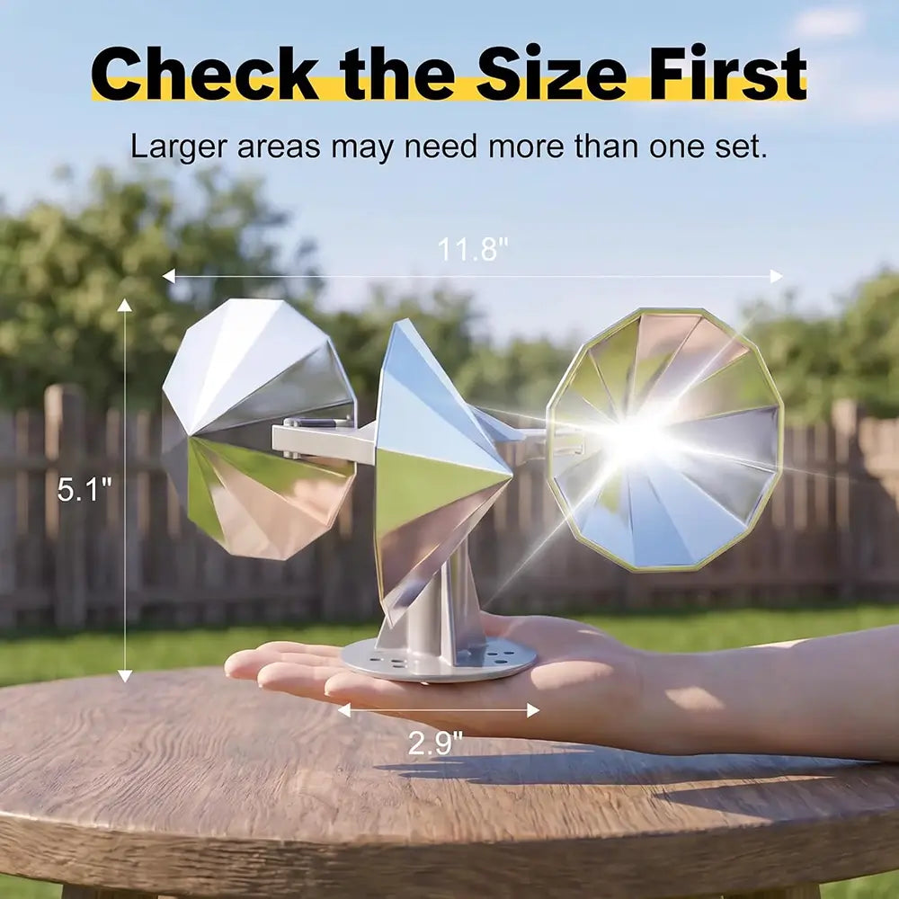 A reflective metal wind spinner displayed outdoors on a wooden table, held in a person's hand for scale. The image includes text overlays showing dimensions: 11.