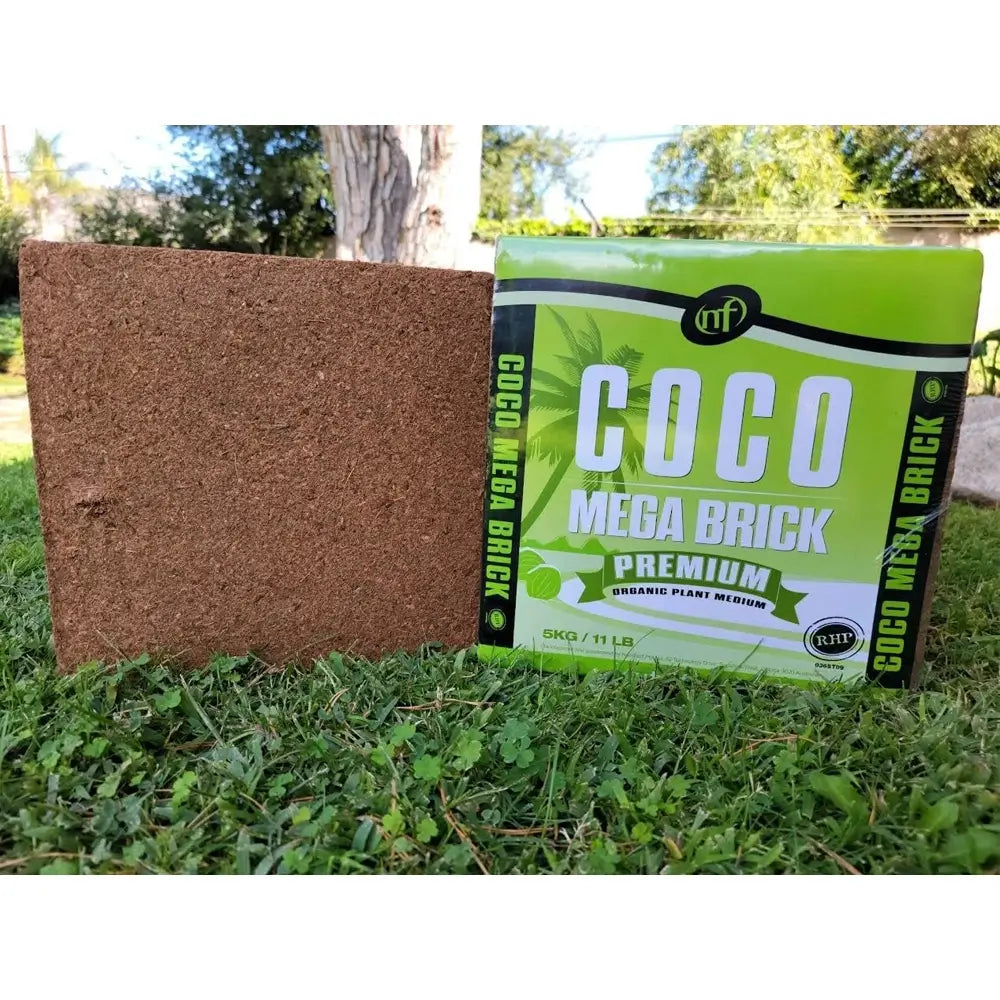 Coco Mega Brick and packaging on grass with trees in the background
