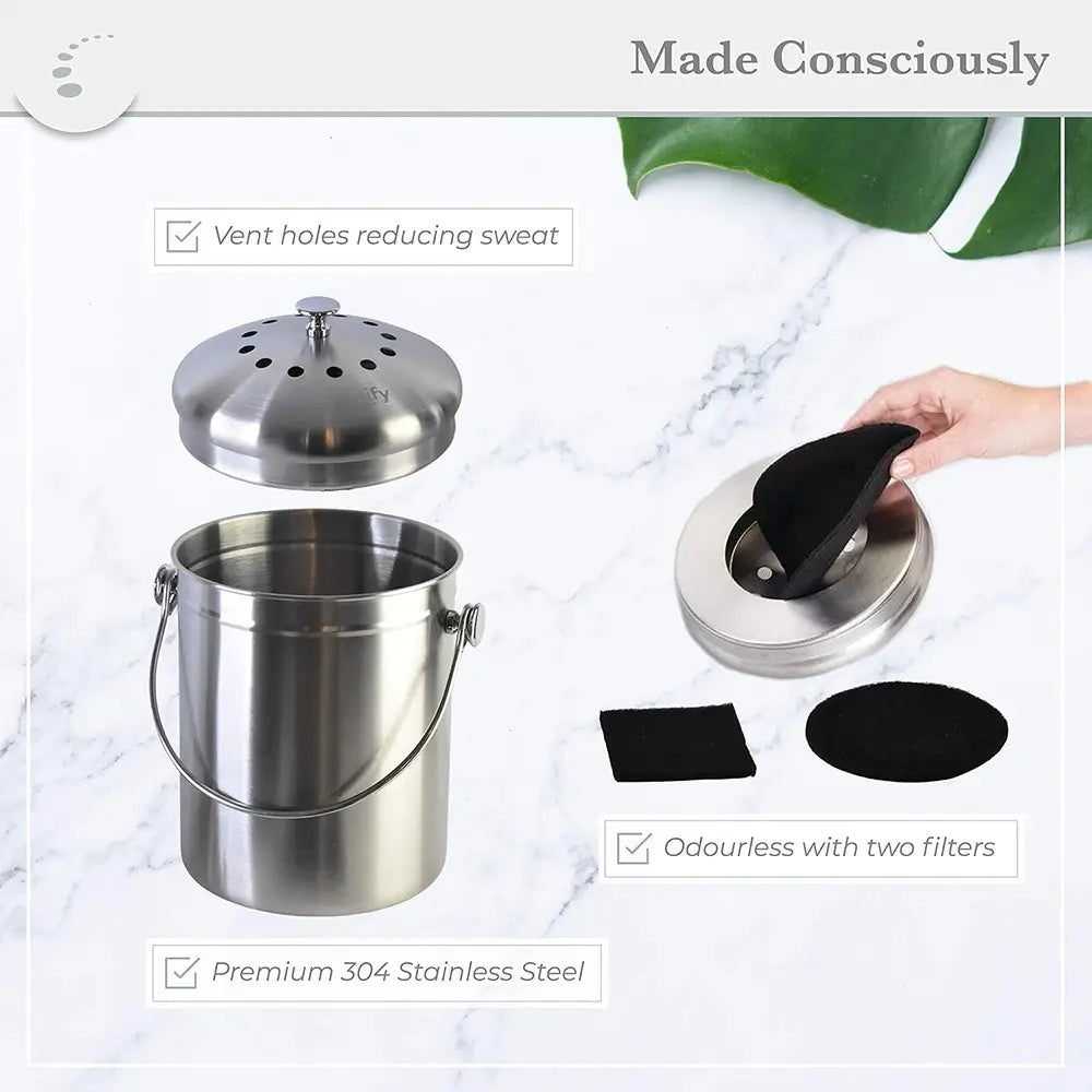 Stainless steel compost bin with lid and filters on a marble surface