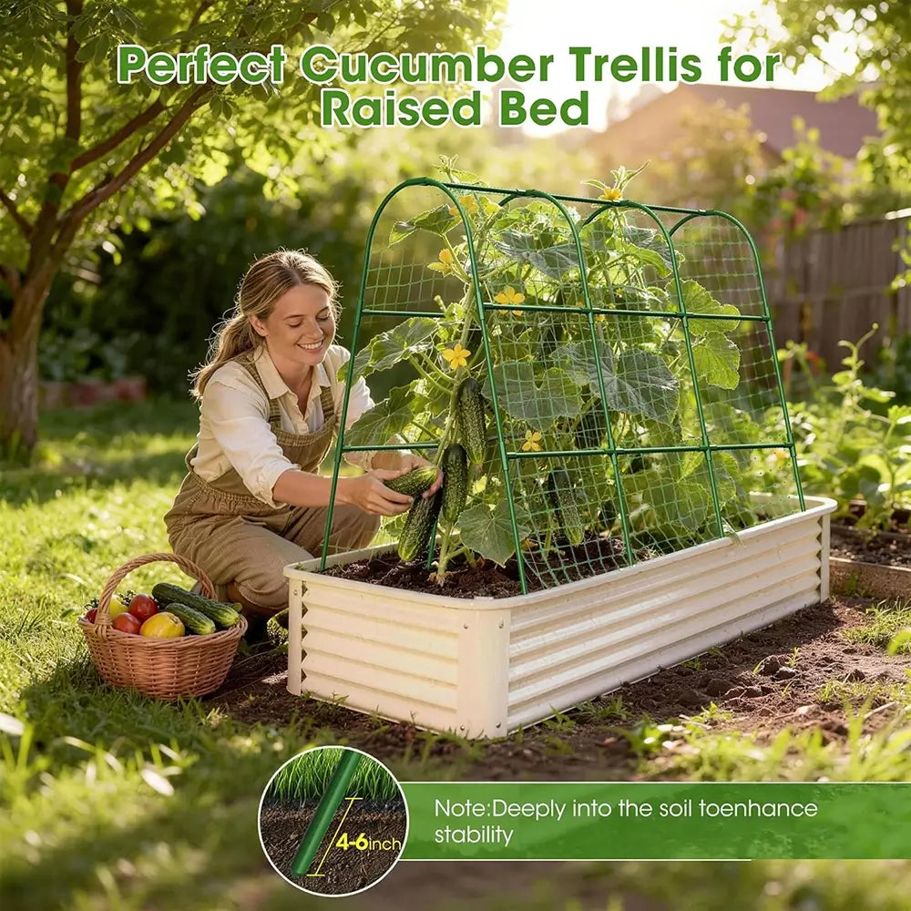 Woman tending to a raised garden bed with a cucumber trellis, surrounded by greenery.