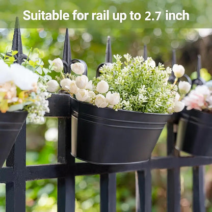 Black metal wall-mounted planters with flowers and greenery on a blurred natural background