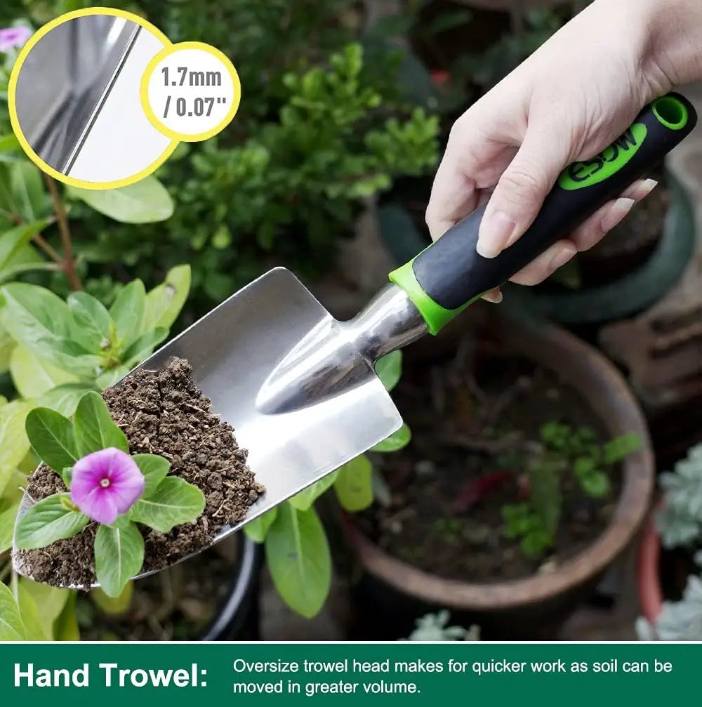 Hand trowel being used to move soil