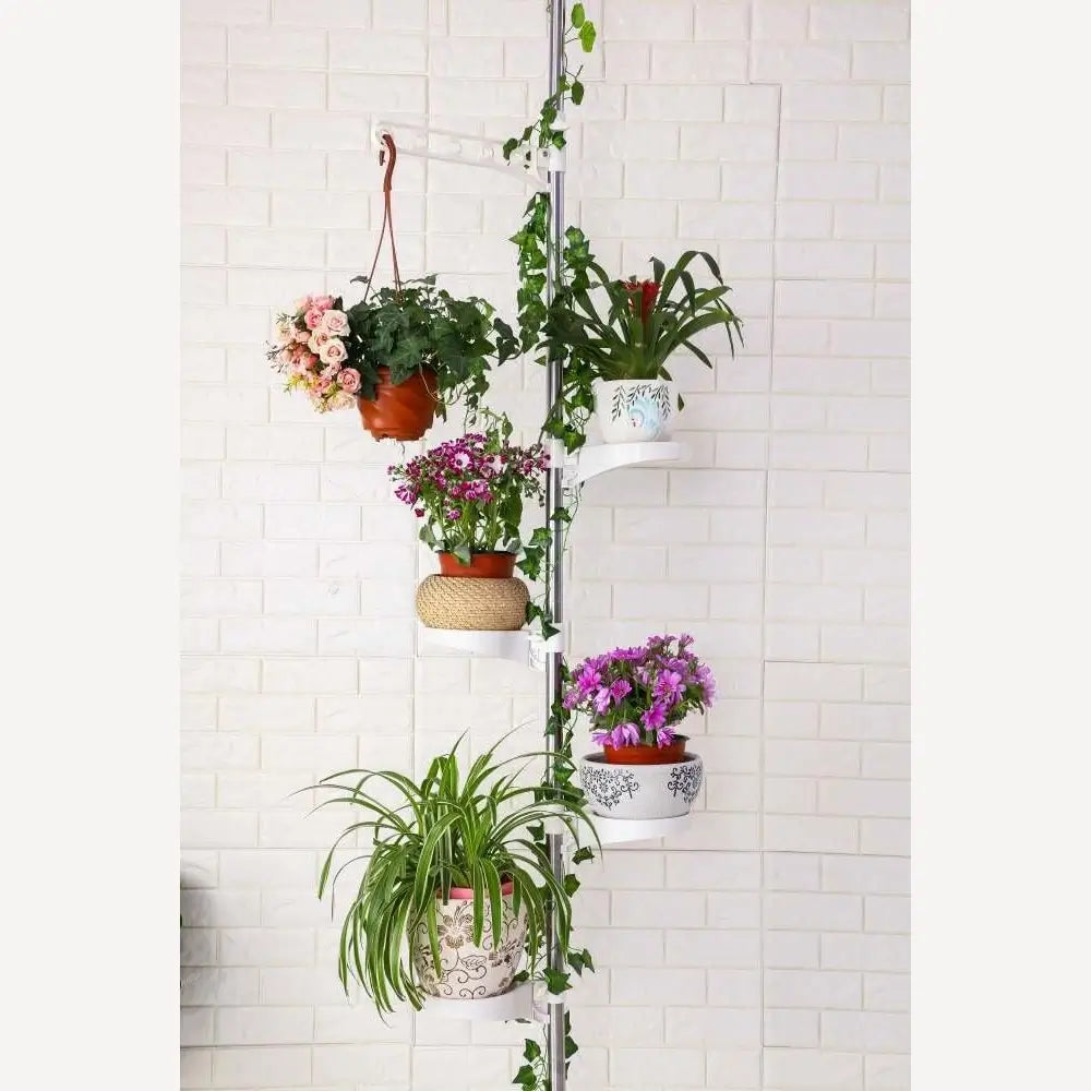 Vertical plant stand with multiple potted plants against a white tiled wall.