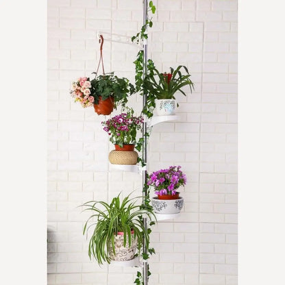 Vertical plant stand with multiple potted plants against a white tiled wall.