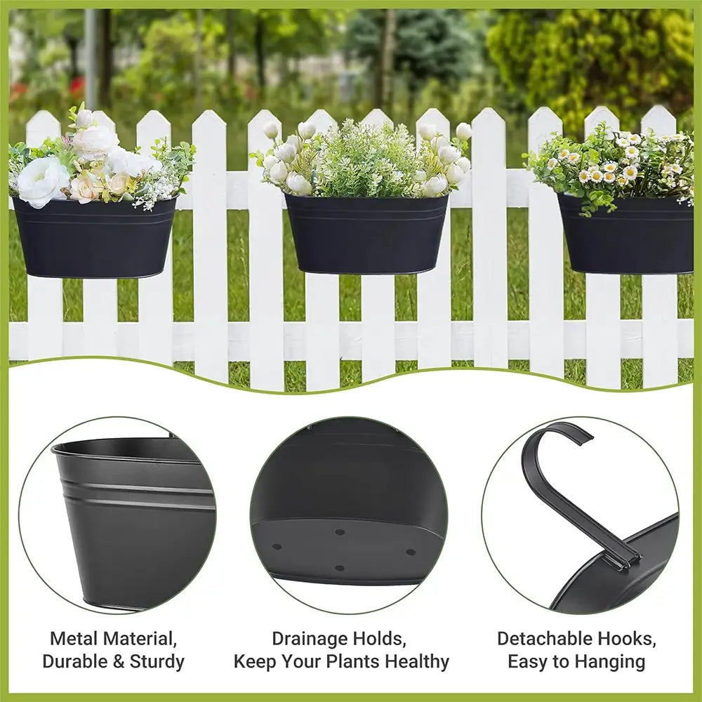 Black wall planters with flowers against a white picket fence, featuring metal material, drainage holes, and detachable hooks.