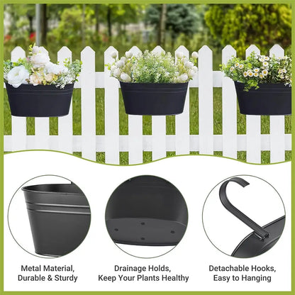 Black wall planters with flowers against a white picket fence, featuring metal material, drainage holes, and detachable hooks.