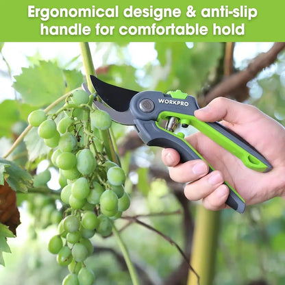 Hand holding a green and black pruning shear with text about ergonomic design and anti-slip handle, against a background of green grapes on a vine.