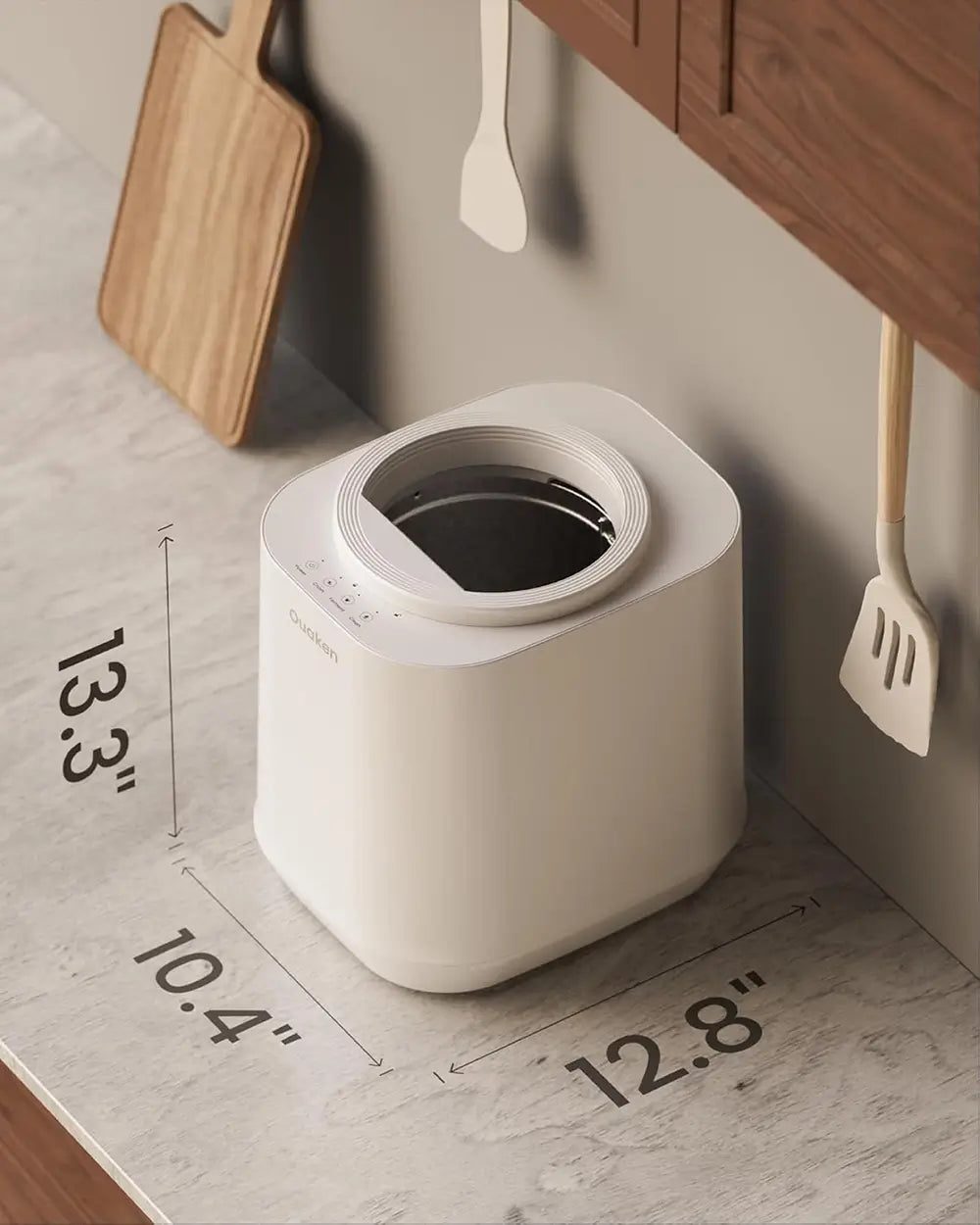 A small white countertop trash bin with a circular opening, shown in a kitchen-like setting with dimension labels overlaid: 13.3 inches tall, 10.