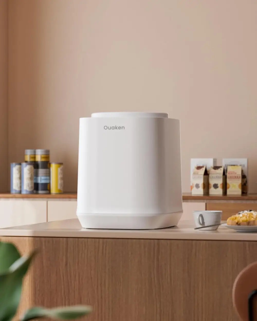 White kitchen appliance on a wooden counter with a neutral background